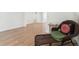 Living area with wood floors, wicker chair, leading into other rooms at 609 Glen Oak Rd, Venice, FL 34293