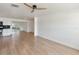 Bright living room featuring sleek wood floors, fresh white paint, and modern ceiling fan at 609 Glen Oak Rd, Venice, FL 34293