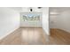 Bright living room with light wood floors and large windows at 609 Glen Oak Rd, Venice, FL 34293