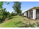 Large, well maintained backyard featuring mature trees, green grass, and a view of the screen porch at 6124 35Th E Ct, Bradenton, FL 34203