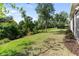 Spacious backyard features green grass, mature trees, and a black metal fence line at the back of the property at 6124 35Th E Ct, Bradenton, FL 34203