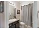 Bathroom with a vanity and sink, patterned shower curtain, and neutral wall colors at 6124 35Th E Ct, Bradenton, FL 34203