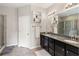 Bathroom with double sinks, granite countertops, and a glass-enclosed shower at 6124 35Th E Ct, Bradenton, FL 34203