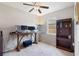 Bedroom with a large desk perfect for a home office, a ceiling fan, and neutral carpet at 6124 35Th E Ct, Bradenton, FL 34203