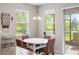 Charming breakfast nook featuring wicker chairs, lots of natural light, and views of the lush backyard at 6124 35Th E Ct, Bradenton, FL 34203