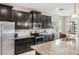 Modern kitchen featuring granite countertops, stainless steel appliances, and dark cabinets at 6124 35Th E Ct, Bradenton, FL 34203