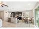 Open-concept kitchen features dark cabinetry, stainless steel appliances, granite countertops, and a breakfast nook at 6124 35Th E Ct, Bradenton, FL 34203