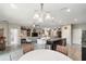 Open floorplan showing kitchen, dining and living area featuring an island with granite countertops and stainless appliances at 6124 35Th E Ct, Bradenton, FL 34203