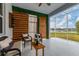 Screened lanai featuring lounge seating, wood-slat accent wall, and a view of the lake at 6312 67Th E St, Bradenton, FL 34203