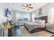 Serene main bedroom with a ceiling fan, plush bedding, and lots of natural light at 6312 67Th E St, Bradenton, FL 34203