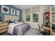 Well-lit bedroom featuring a cozy bed, study area and modern decor at 6908 Prairie Oak Way, Nokomis, FL 34275
