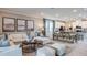 Spacious living room featuring modern decor, an open floor plan, and plenty of natural light at 6908 Prairie Oak Way, Nokomis, FL 34275