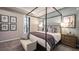 Comfortable main bedroom featuring neutral decor, a sitting area, and a large window at 6908 Prairie Oak Way, Nokomis, FL 34275