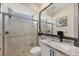 Updated bathroom with a modern vanity, glass-enclosed shower, and neutral tile at 7034 Honeysuckle Trl, Lakewood Ranch, FL 34202