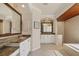 Luxurious bathroom with dual vanities, granite countertops, and a spa-like shower and tub at 7034 Honeysuckle Trl, Lakewood Ranch, FL 34202