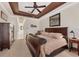 Spacious bedroom with a dark wood furniture set, neutral walls, and a view of a hallway at 7034 Honeysuckle Trl, Lakewood Ranch, FL 34202