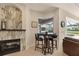 Cozy breakfast nook with a fireplace, table, and views to the backyard pool at 7034 Honeysuckle Trl, Lakewood Ranch, FL 34202