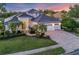 Stunning single-Gathering home featuring a well-manicured lawn and a three-car garage at 7034 Honeysuckle Trl, Lakewood Ranch, FL 34202
