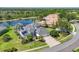 Stunning home with a manicured lawn, mature trees, and a serene pond backdrop, enhancing its curb appeal at 7034 Honeysuckle Trl, Lakewood Ranch, FL 34202