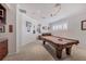 Spacious game room with a pool table and a window for natural light at 7034 Honeysuckle Trl, Lakewood Ranch, FL 34202