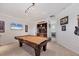 Spacious game room with a billiard table, wet bar, and built-in shelving for entertainment at 7034 Honeysuckle Trl, Lakewood Ranch, FL 34202