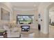 Bright living room with fireplace, large window overlooking the water, and elegant decor at 7034 Honeysuckle Trl, Lakewood Ranch, FL 34202