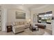 Comfortable living room featuring a cozy couch, round rug, and view to the backyard at 7034 Honeysuckle Trl, Lakewood Ranch, FL 34202