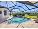 Private screened pool with spa, surrounded by lush landscaping and serene waterfront views at 7034 Honeysuckle Trl, Lakewood Ranch, FL 34202