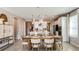 Elegant dining area with a wooden table, seating for six, and bright lighting fixtures at 7048 Foxboro Way, Nokomis, FL 34275