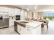 Gourmet kitchen featuring stainless steel appliances, a large island, and modern cabinetry at 7048 Foxboro Way, Nokomis, FL 34275