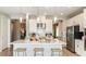 Modern kitchen featuring a large center island, stainless steel appliances, and pendant lighting at 7048 Foxboro Way, Nokomis, FL 34275