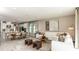 Spacious living room and kitchen, featuring neutral decor and ample natural light at 7048 Foxboro Way, Nokomis, FL 34275
