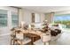 Bright, open-concept living and dining area with luxury finishes and abundant natural light at 7048 Foxboro Way, Nokomis, FL 34275