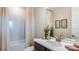 Well-lit bathroom with large mirror features quartz countertops, and modern decor at 7052 Foxboro Way, Nokomis, FL 34275