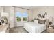 Bright bedroom features carpeted floors, a comfortable queen size bed, and large windows at 7052 Foxboro Way, Nokomis, FL 34275