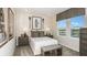 Modern bedroom featuring carpeted floors, matching nightstands, and lacrosse themed decor at 7052 Foxboro Way, Nokomis, FL 34275