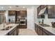 This spacious kitchen features stainless steel appliances, dark cabinets, and a stylish backsplash at 7052 Foxboro Way, Nokomis, FL 34275