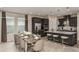 Open-concept kitchen with stainless steel appliances and a dining area perfect for entertaining guests at 7052 Foxboro Way, Nokomis, FL 34275