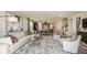 Spacious living room leading to the open kitchen area with dining space and plenty of natural light at 7052 Foxboro Way, Nokomis, FL 34275