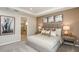 Comfortable main bedroom features a queen size bed, carpeted floors and ensuite bathroom at 7052 Foxboro Way, Nokomis, FL 34275