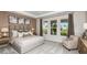 Bright main bedroom features large windows, a sitting area, carpeted floors and neutral decor at 7052 Foxboro Way, Nokomis, FL 34275