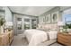 Bright bedroom features neutral decor, large windows, and tasteful furnishings at 7053 Foxboro Way, Nokomis, FL 34275