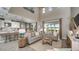 Inviting living room featuring comfortable seating, an open floor plan, and sliding glass doors to the outdoors at 7053 Foxboro Way, Nokomis, FL 34275