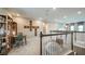 Upstairs loft with railing and comfortable seating area is ideal for relaxing at 7053 Foxboro Way, Nokomis, FL 34275