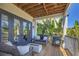 Outdoor balcony features comfortable seating, a grill, and views of lush greenery and tropical foliage at 7142 Hawks Harbor Cir, Bradenton, FL 34207