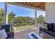 Outdoor balcony features comfortable seating, a grill, and picturesque views of lush greenery and water at 7142 Hawks Harbor Cir, Bradenton, FL 34207