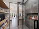 Modern bathroom featuring glass shower and walk-in closet with wood shelves at 7142 Hawks Harbor Cir, Bradenton, FL 34207
