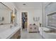 Elegant bathroom boasts a soaking tub, walk-in shower, and a large vanity with modern fixtures at 7142 Hawks Harbor Cir, Bradenton, FL 34207