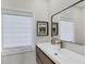 Bathroom with neutral colors, minimalist vanity, and framed wall art at 7142 Hawks Harbor Cir, Bradenton, FL 34207