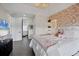 Bedroom with white bedding, flower wall, and a view into the bathroom at 7142 Hawks Harbor Cir, Bradenton, FL 34207